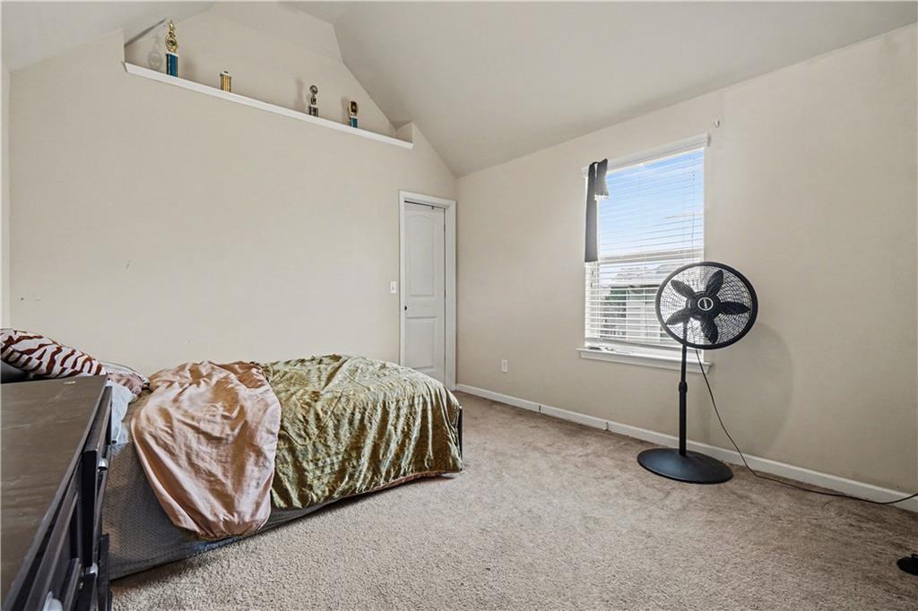 4157 Sublime Trail Atlanta, GA 30349 - Photo 19 of 20 a bedroom with a bed and chandelier