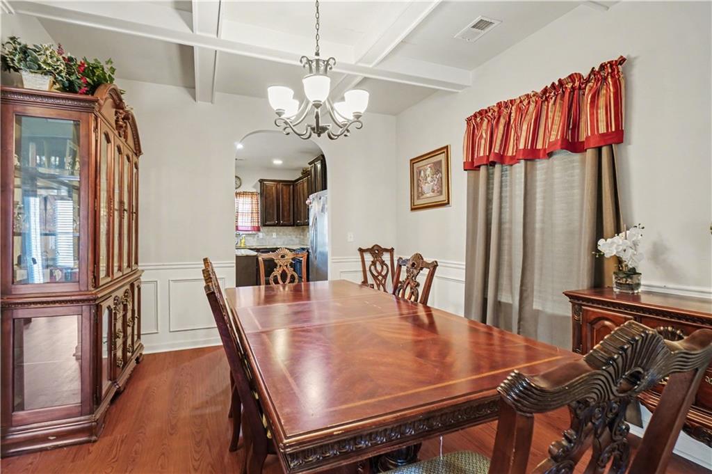 4157 Sublime Trail Atlanta, GA 30349 - Photo 5 of 20 a dining room with furniture a chandelier and wooden floor