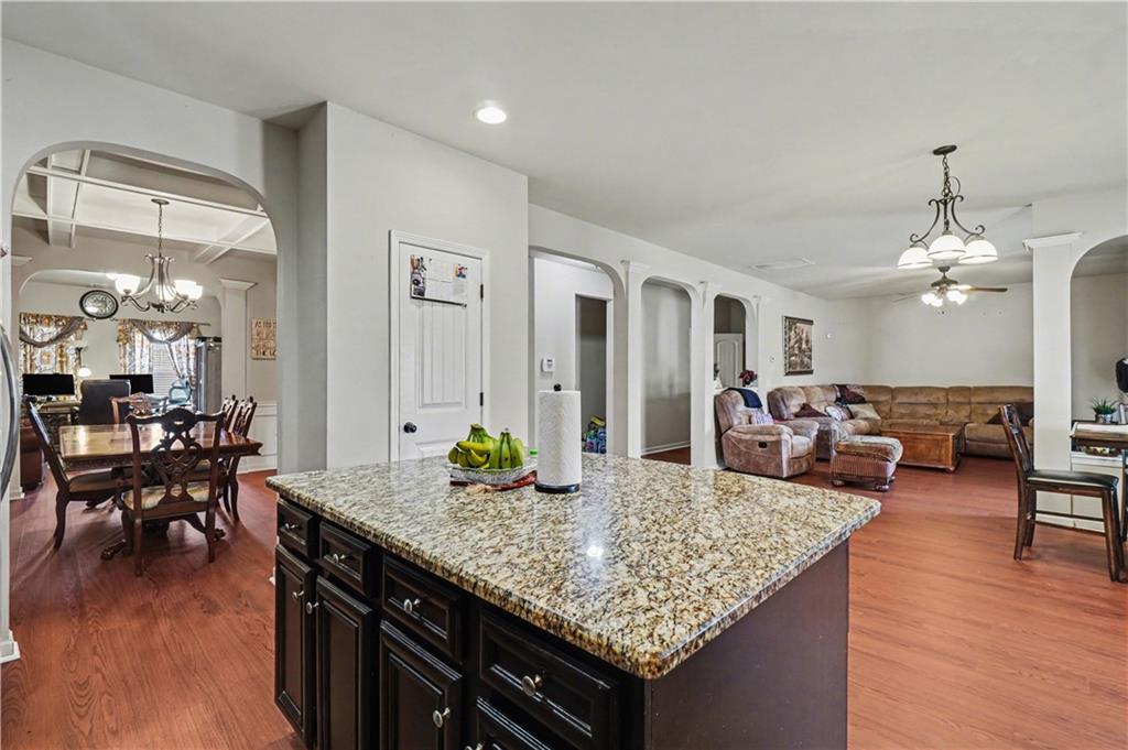 4157 Sublime Trail Atlanta, GA 30349 - Photo 6 of 20 a view of a dining room and livingroom with furniture wooden floor a chandelier