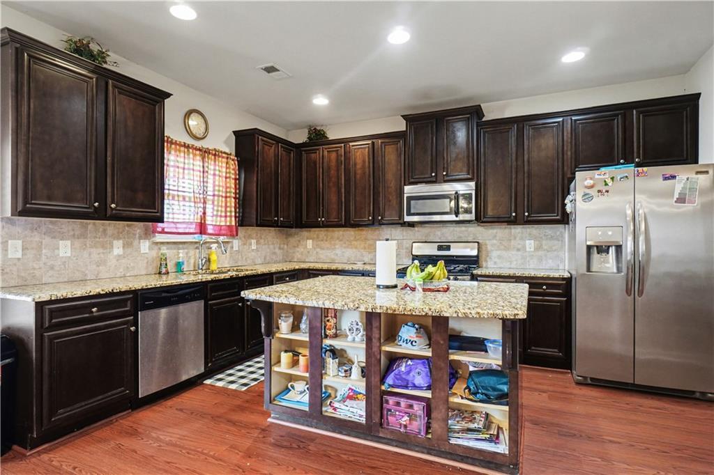 4157 Sublime Trail Atlanta, GA 30349 - Photo 7 of 20 a kitchen with stainless steel appliances granite countertop a refrigerator stove microwave and sink