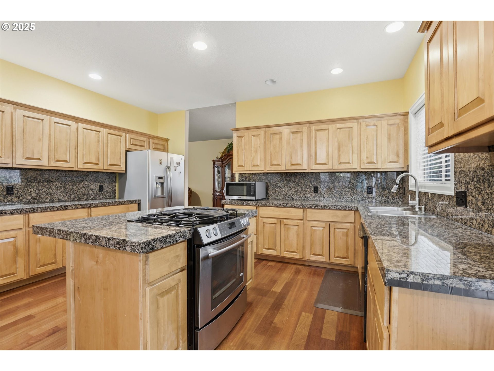 3718 Southeast 127th Place Portland, OR 97236 - Photo 12 of 31 a kitchen with stainless steel appliances granite countertop a stove a sink and a granite counter tops