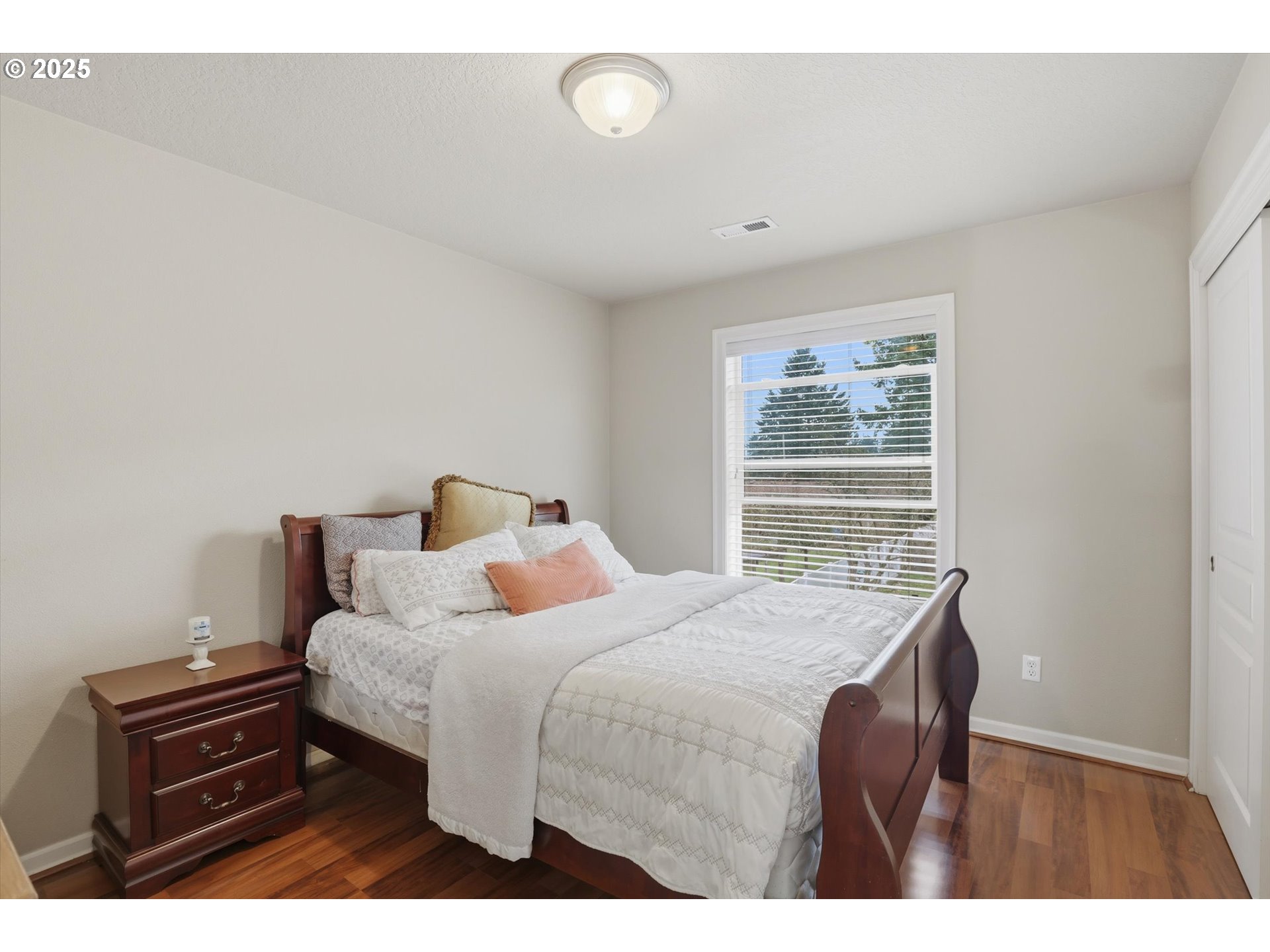 3718 Southeast 127th Place Portland, OR 97236 - Photo 21 of 31 a bedroom with a bed next to a window