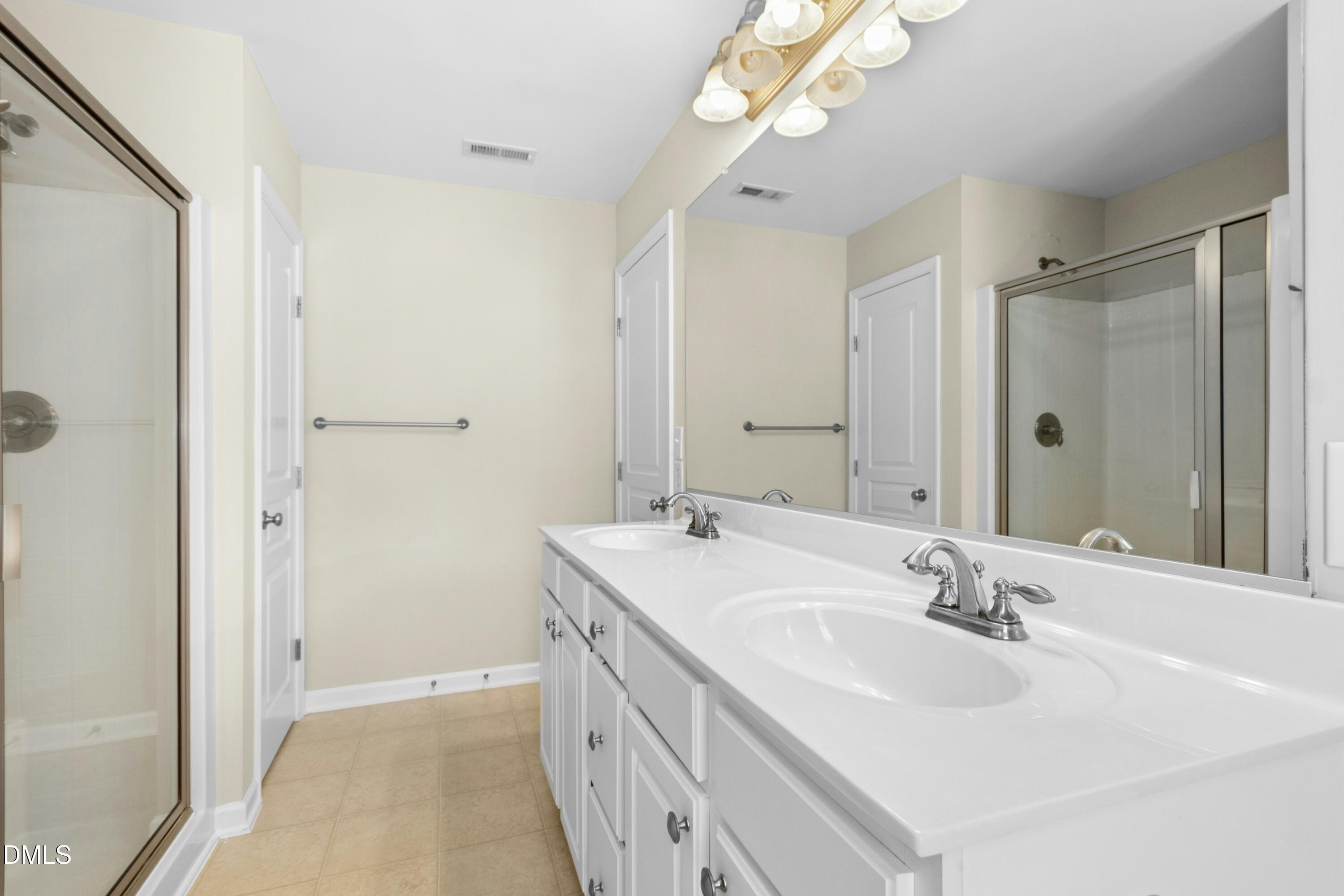 5541 Nur Lane Raleigh, NC 27606 - Photo 23 of 33 a bathroom with a sink a vanity and a mirror