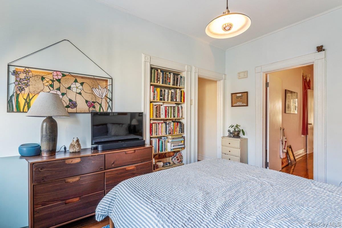 62 Sutton Street Brooklyn, NY 11222 - Photo 12 of 29 a bedroom with a bed and a flat screen tv