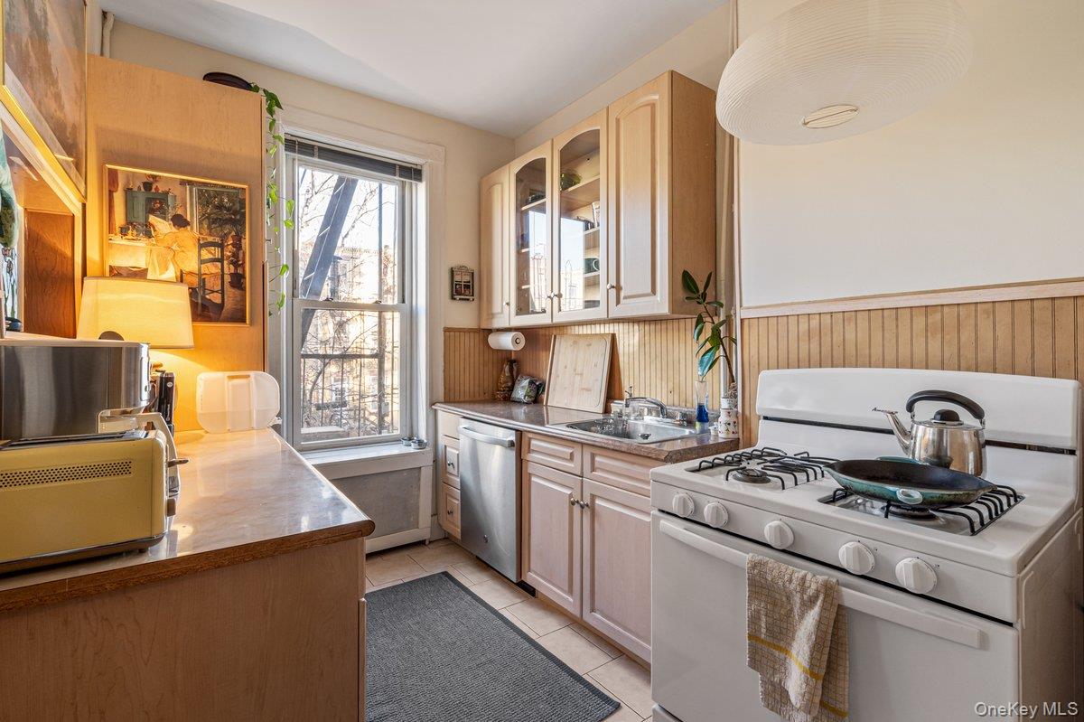 62 Sutton Street Brooklyn, NY 11222 - Photo 13 of 29 a kitchen with sink a stove and a window