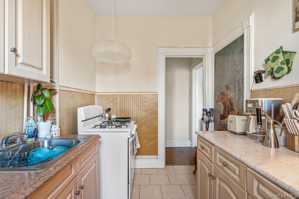 62 Sutton Street Brooklyn, NY 11222 - Photo 14 of 29 a kitchen with a sink stove and cabinets
