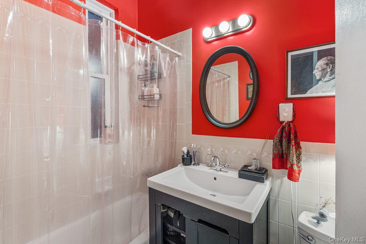 62 Sutton Street Brooklyn, NY 11222 - Photo 15 of 29 a bathroom with a sink and a mirror