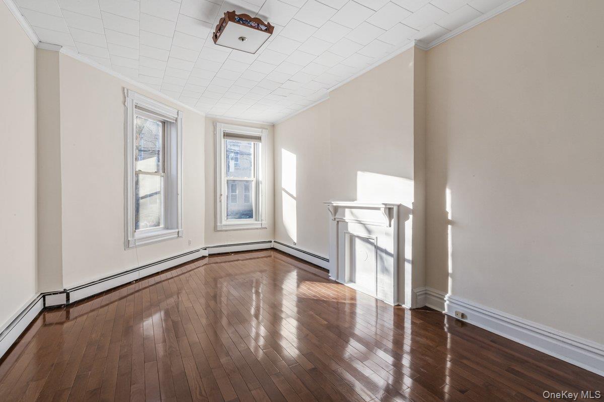 62 Sutton Street Brooklyn, NY 11222 - Photo 18 of 29 a view of empty room with wooden floor and fan