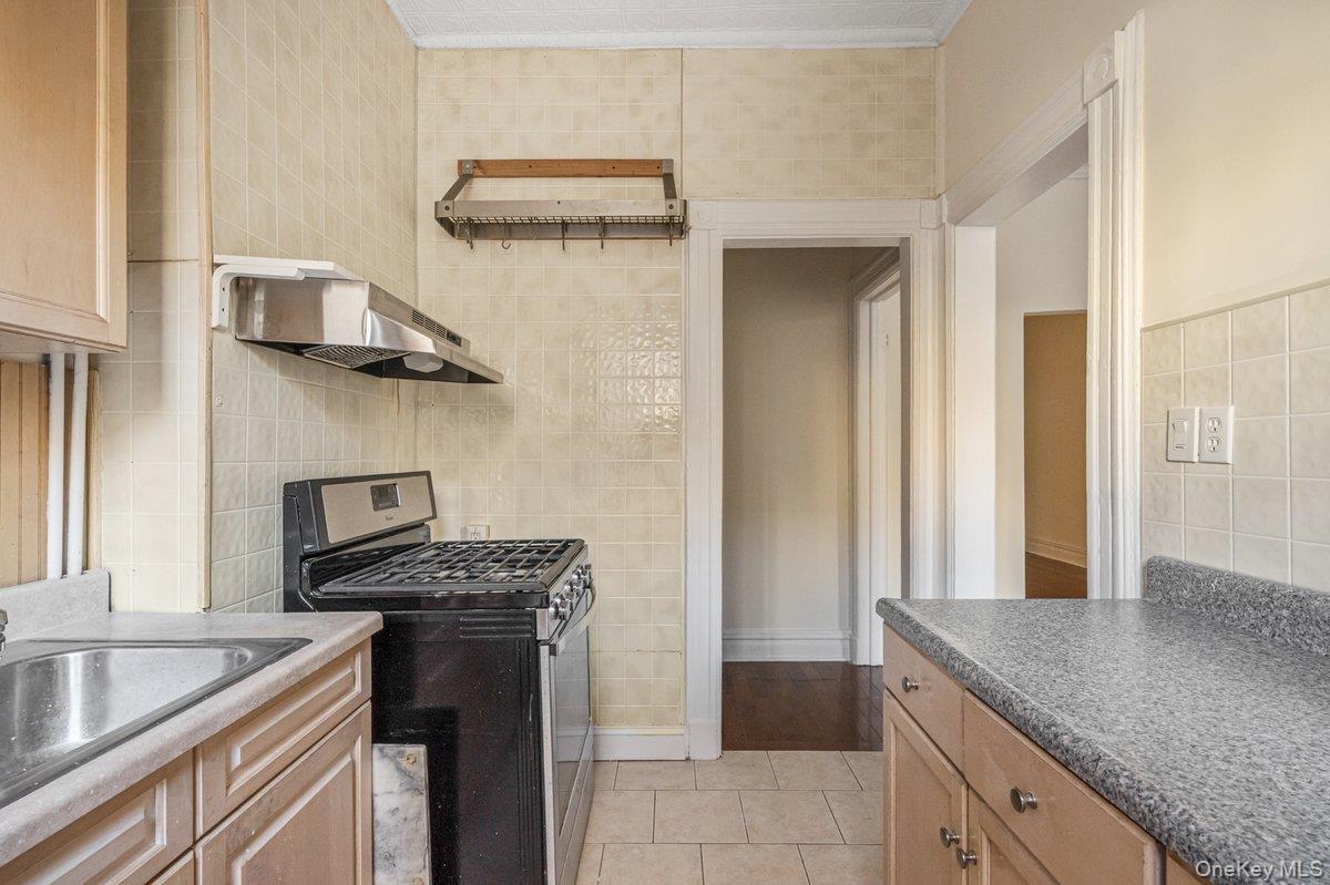 62 Sutton Street Brooklyn, NY 11222 - Photo 26 of 29 a kitchen with stainless steel appliances granite countertop a sink and a stove