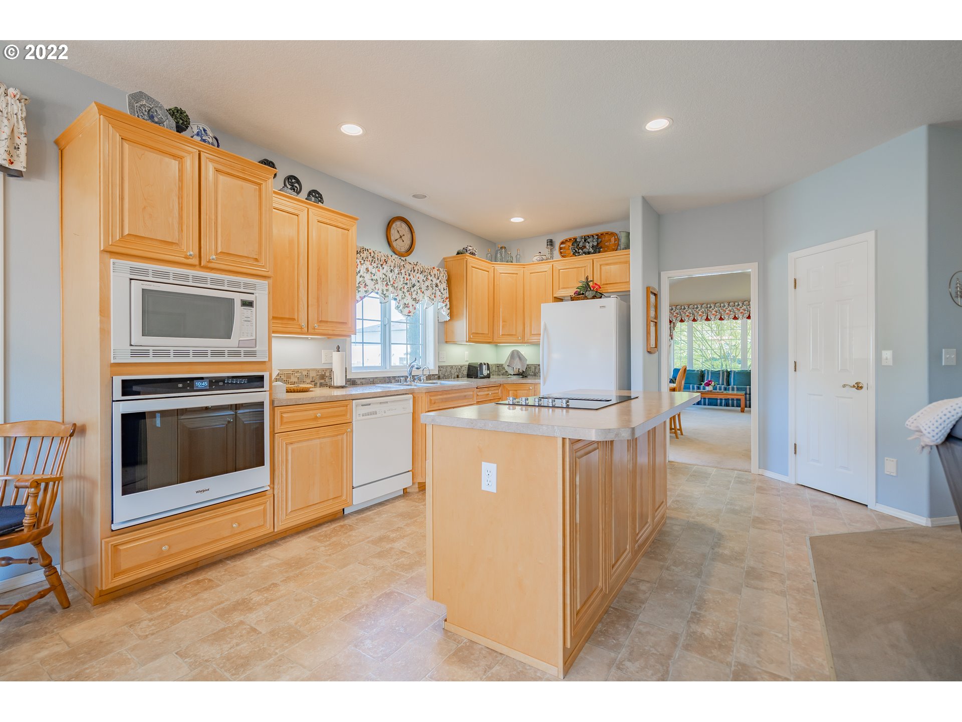 3711 Northwest 114th Street Vancouver, WA 98685 - Photo 13 of 32 a kitchen with stainless steel appliances kitchen island granite countertop a stove a sink and a microwave
