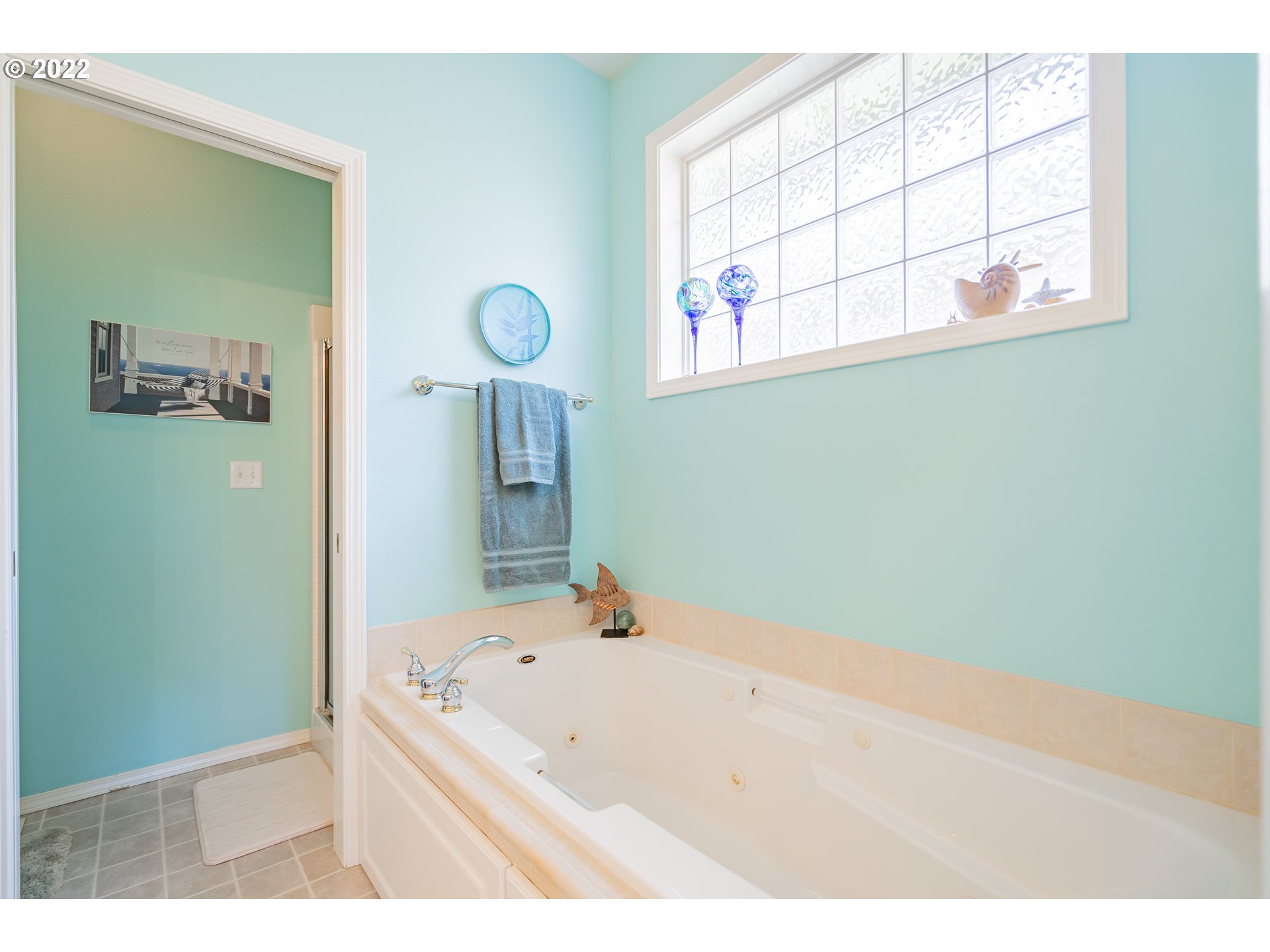 3711 Northwest 114th Street Vancouver, WA 98685 - Photo 20 of 32 a bathroom with a tub a sink and a window