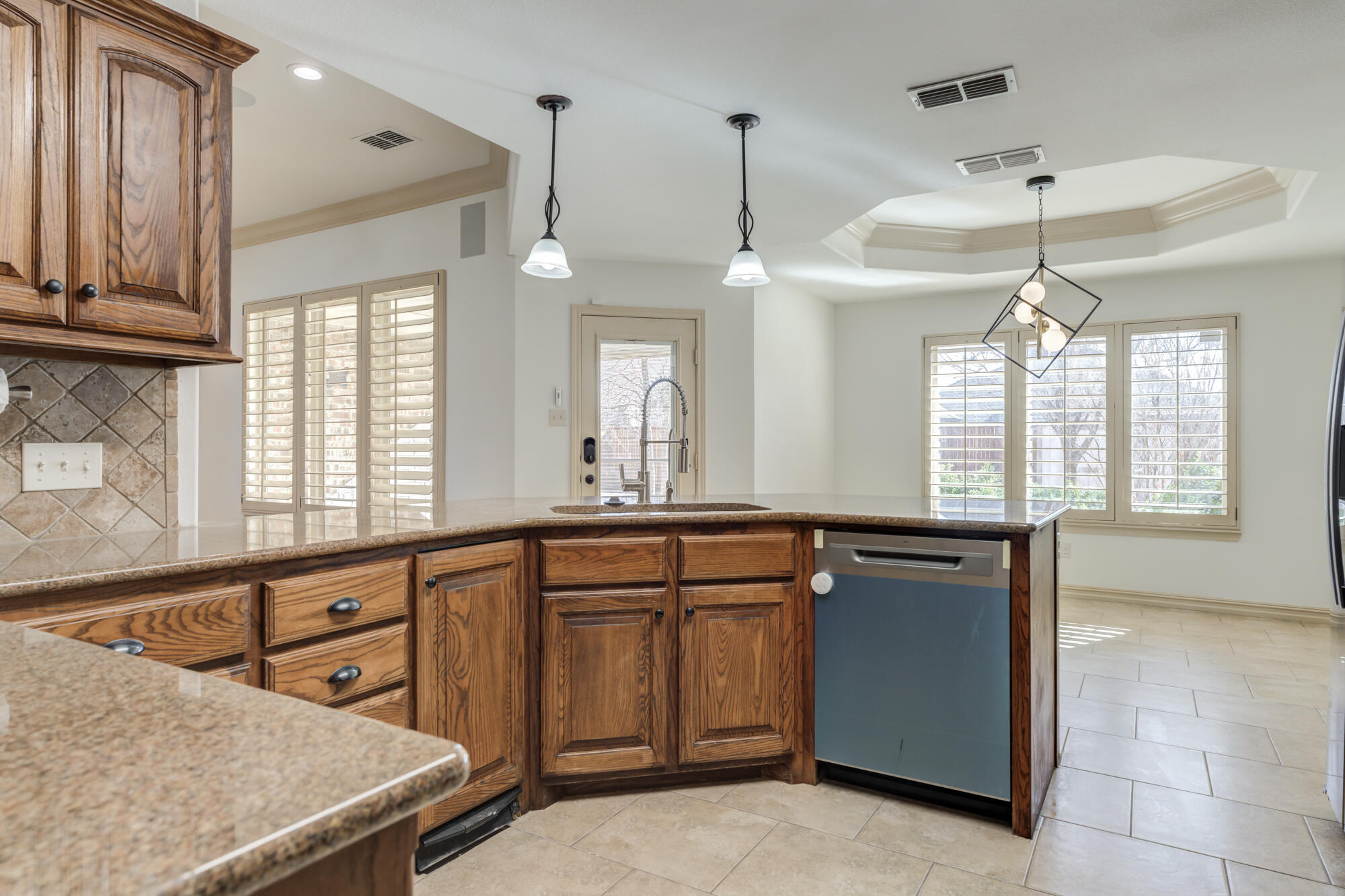 6509 72nd Street Lubbock, TX 79424 - Photo 13 of 40 a kitchen with stainless steel appliances granite countertop a stove a sink and a refrigerator