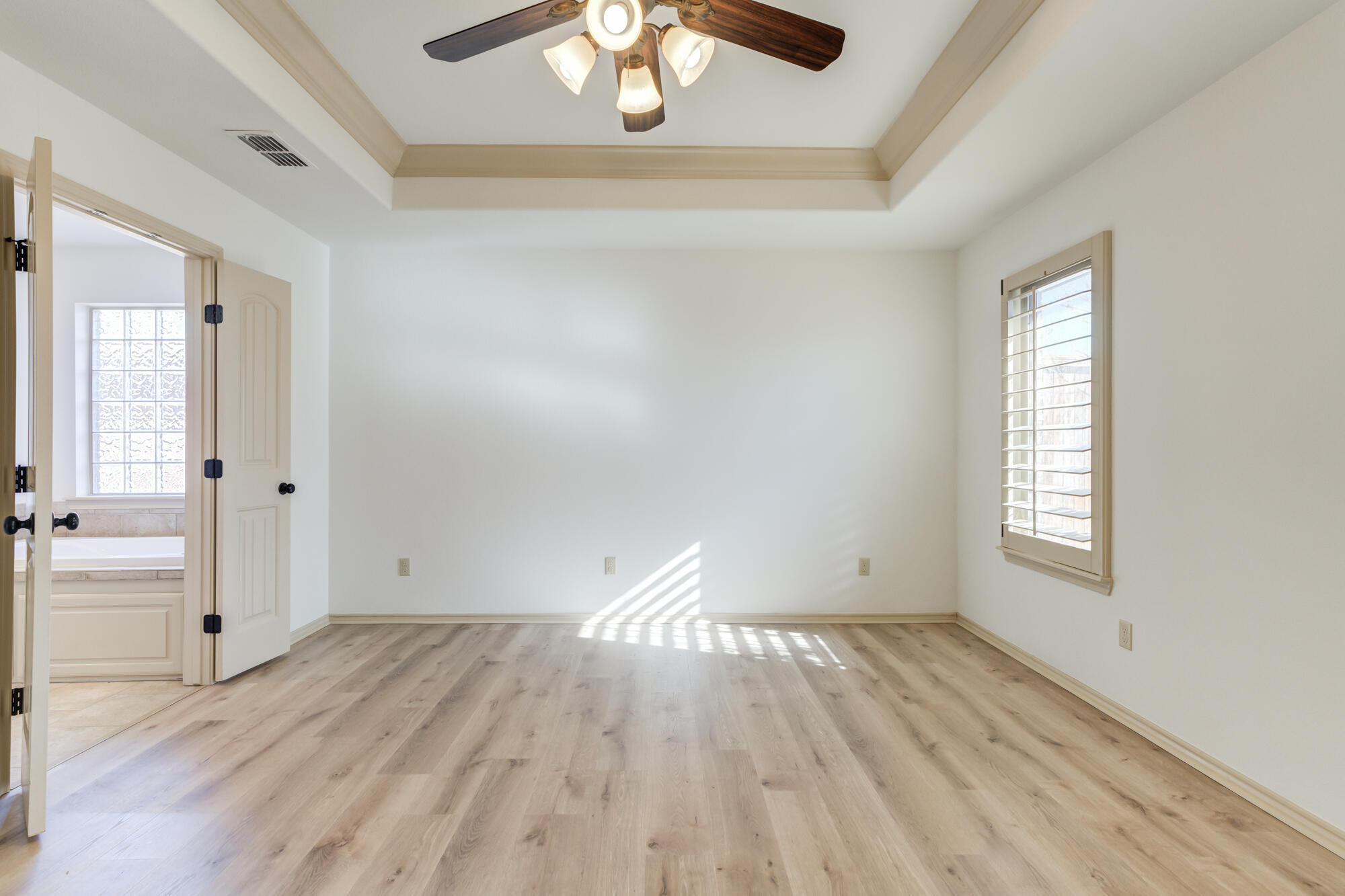 6509 72nd Street Lubbock, TX 79424 - Photo 18 of 40 an empty room with wooden floor and windows