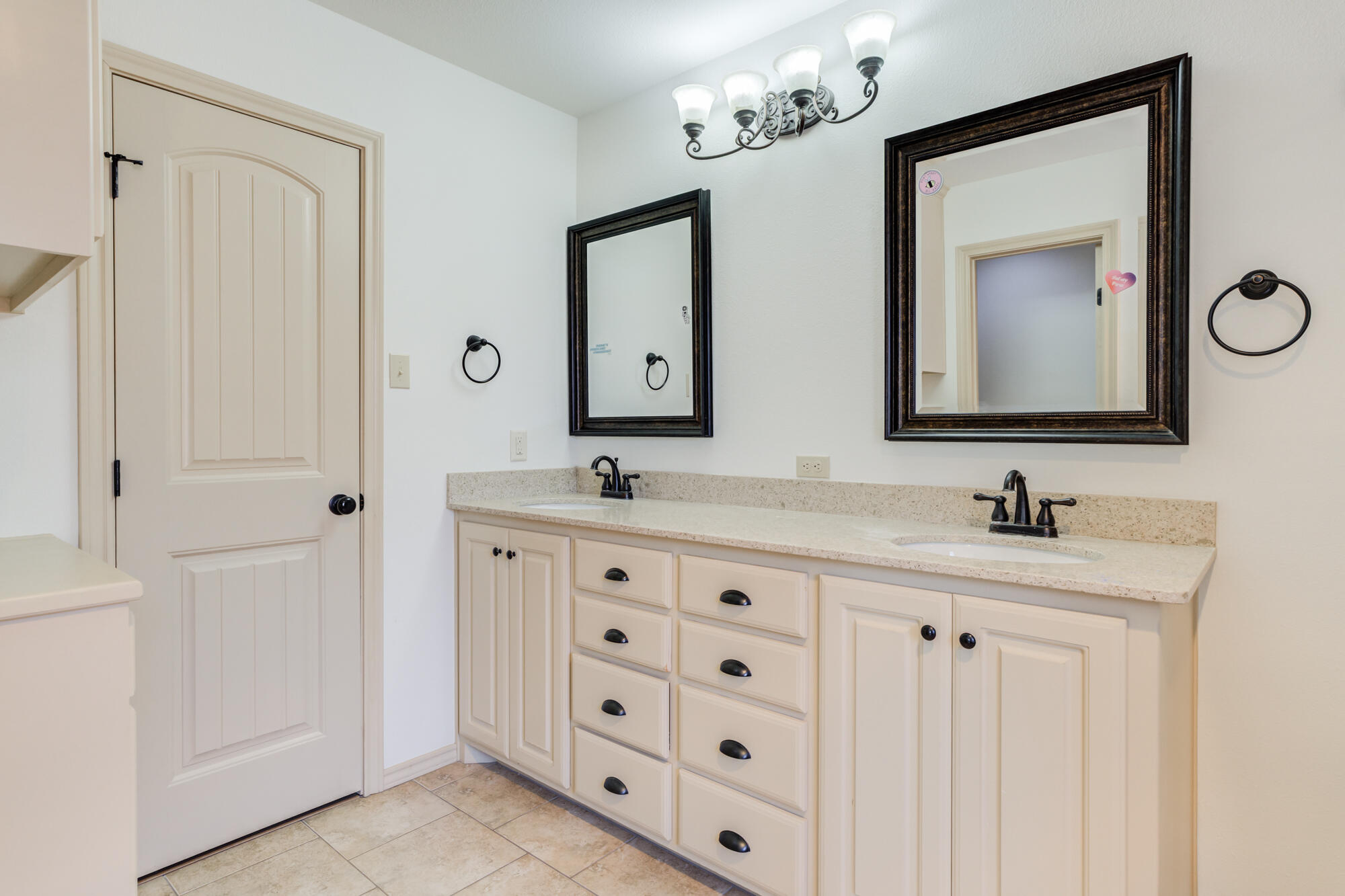 6509 72nd Street Lubbock, TX 79424 - Photo 22 of 40 a bathroom with double sink and a mirror