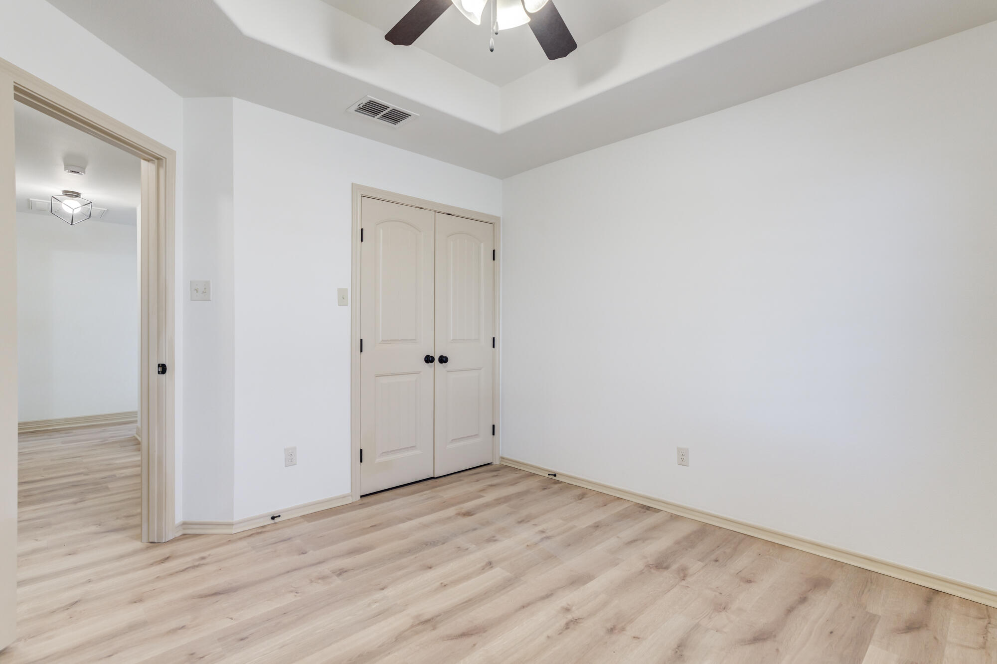 6509 72nd Street Lubbock, TX 79424 - Photo 27 of 40 an empty room with wooden floor and a ceiling fan