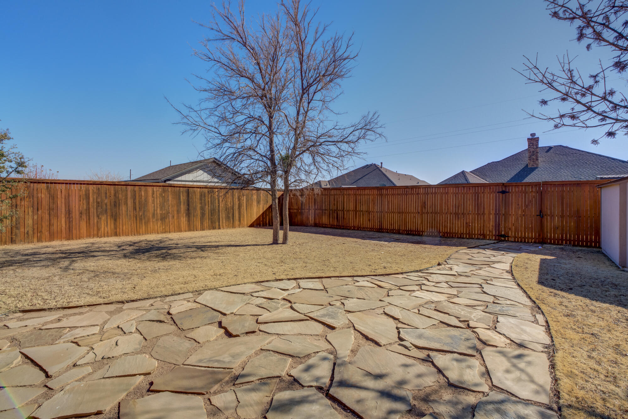 6509 72nd Street Lubbock, TX 79424 - Photo 37 of 40 a street view with wooden fence
