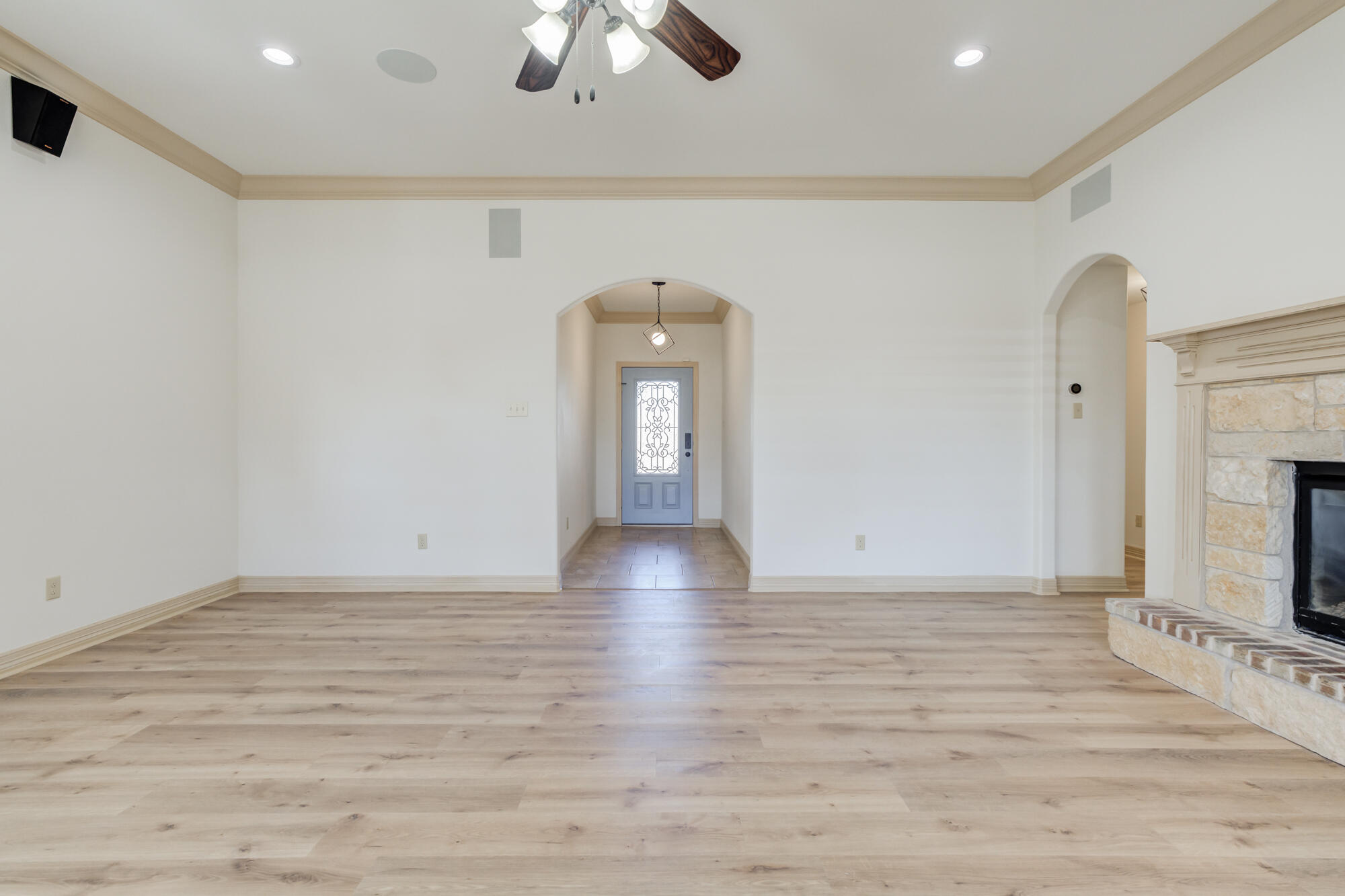 6509 72nd Street Lubbock, TX 79424 - Photo 4 of 40 a view of a livingroom with wooden floor and a ceiling fan