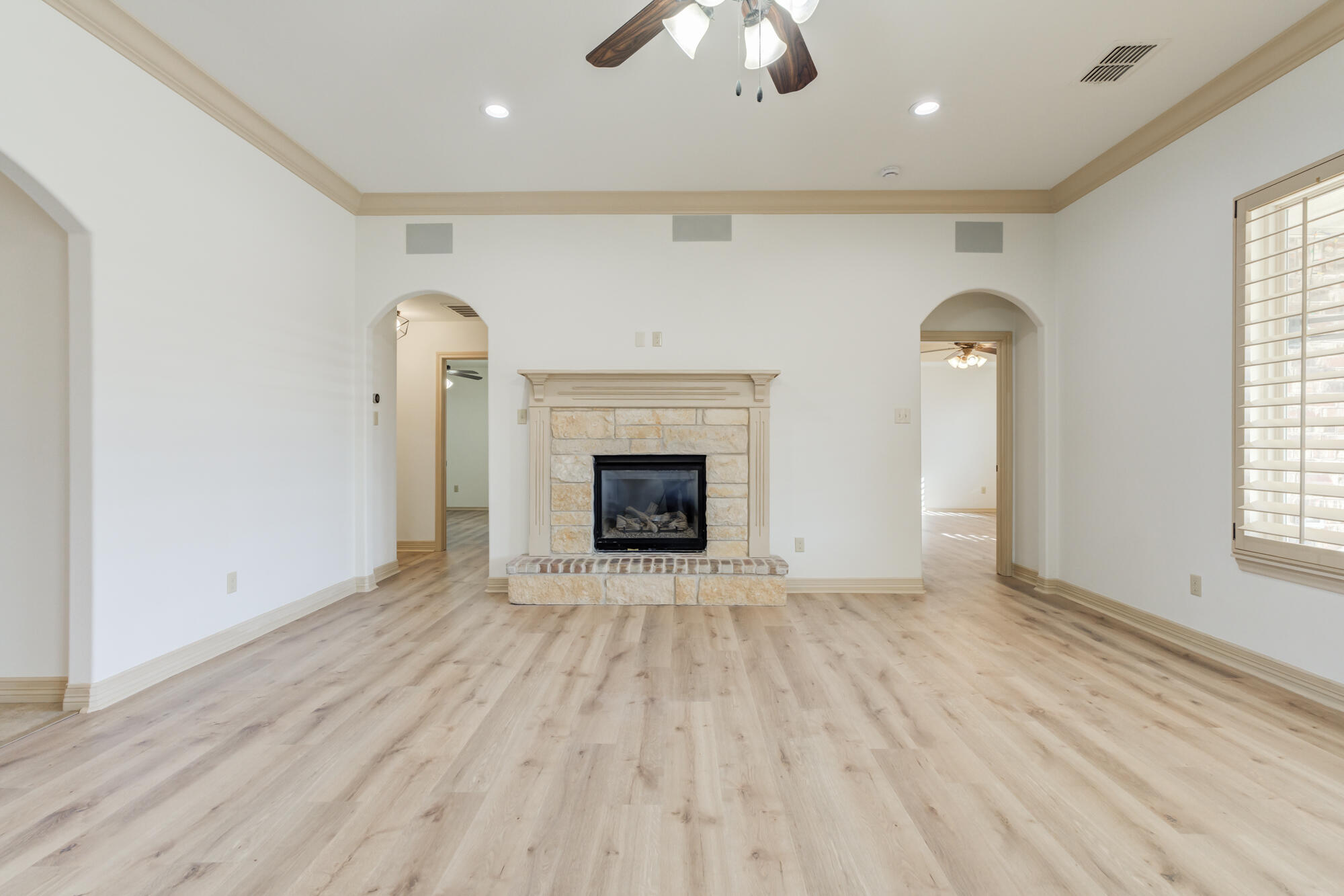 6509 72nd Street Lubbock, TX 79424 - Photo 5 of 40 an empty room with windows and fireplace