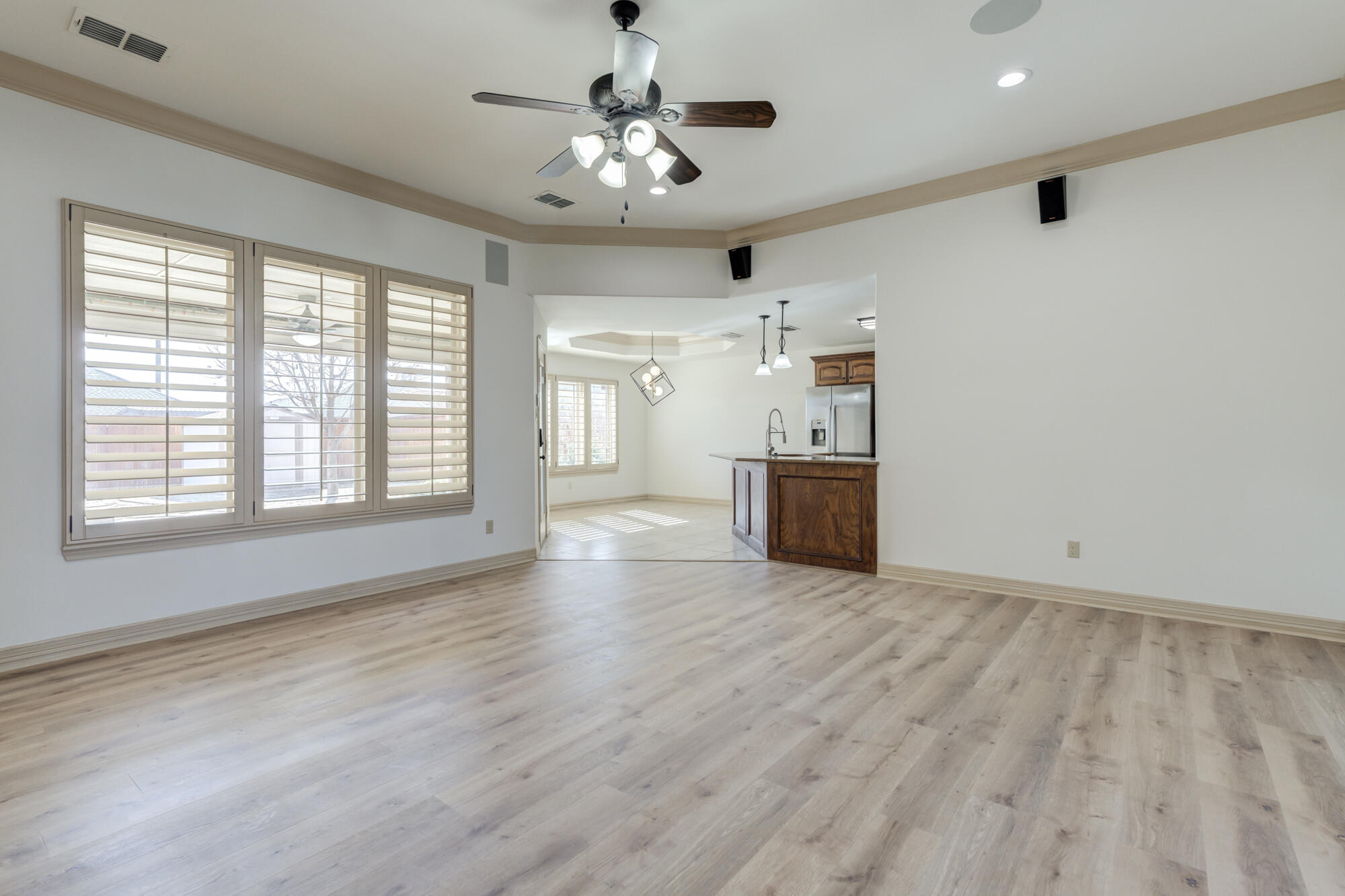 6509 72nd Street Lubbock, TX 79424 - Photo 8 of 40 a view of a livingroom with wooden floor and a ceiling fan