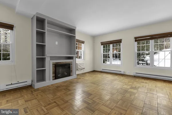 a view of a livingroom with a fireplace and window