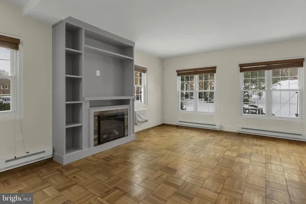a view of kitchen with stainless steel appliances cabinets and empty room
