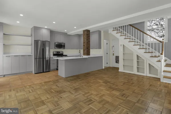 a view of a livingroom with a fireplace and window