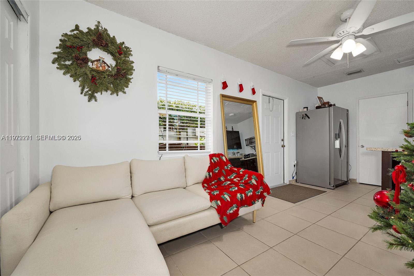 7420 Southwest 31st Street, Unit 2 Miami, FL 33155 - Photo 4 of 10 a living room with furniture and a chandelier
