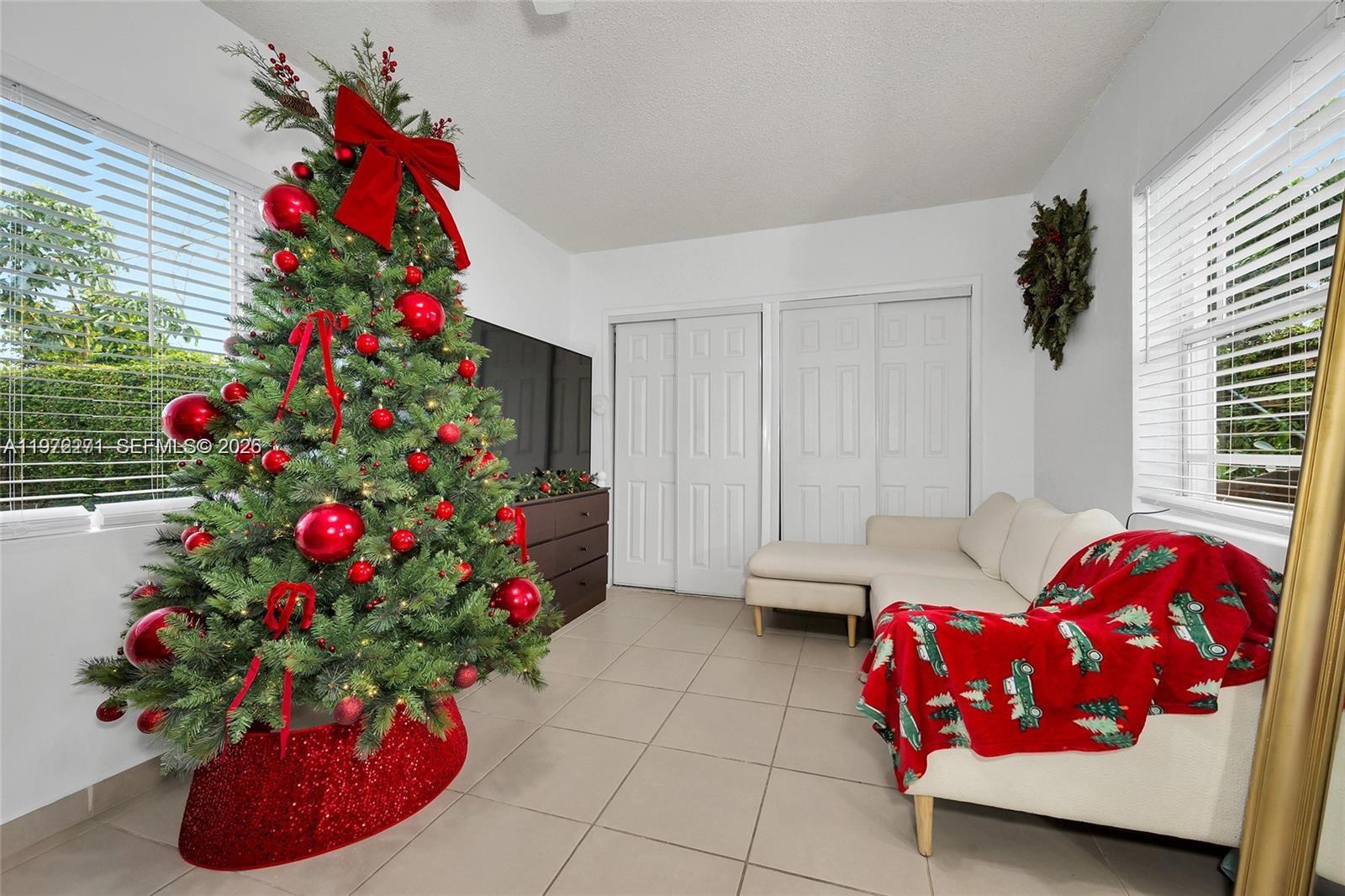 7420 Southwest 31st Street, Unit 2 Miami, FL 33155 - Photo 5 of 10 a bedroom with a bed and a potted plant