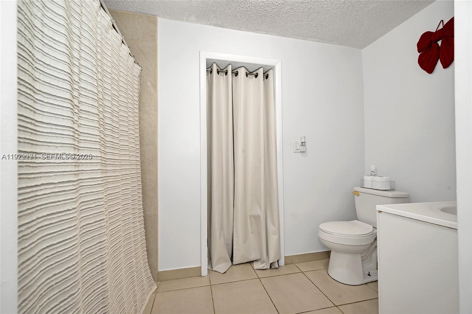 7420 Southwest 31st Street, Unit 2 Miami, FL 33155 - Photo 6 of 10 a bathroom with a toilet and a shower
