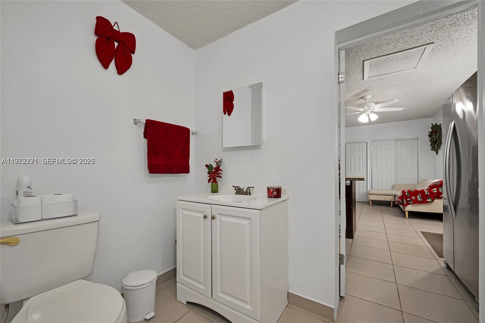 7420 Southwest 31st Street, Unit 2 Miami, FL 33155 - Photo 7 of 10 a bathroom with a toilet sink and mirror