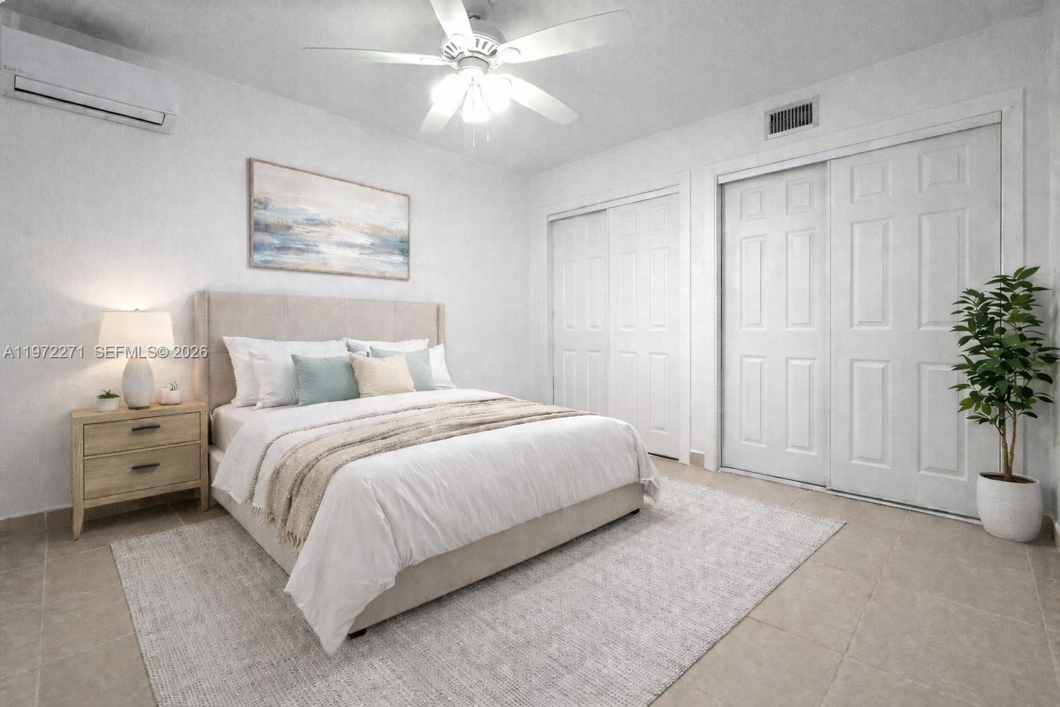 7420 Southwest 31st Street, Unit 2 Miami, FL 33155 - Photo 8 of 10 a spacious bedroom with a bed and a chandelier