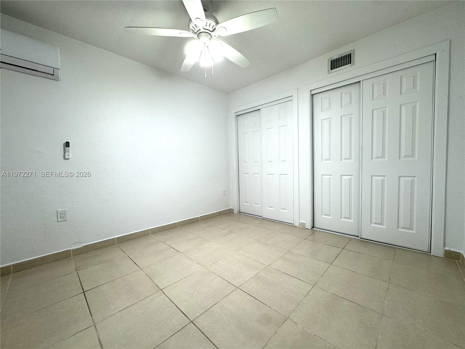7420 Southwest 31st Street, Unit 2 Miami, FL 33155 - Photo 9 of 10 an empty room with a ceiling fan and a window