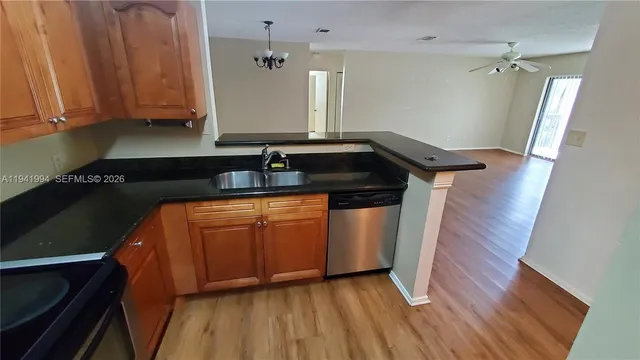 a kitchen with wooden floor and a sink