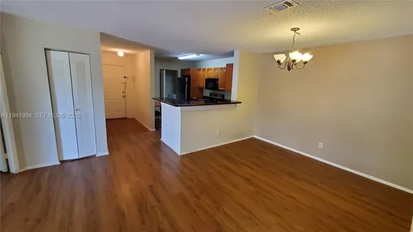 a view of a room with wooden floor and staircase