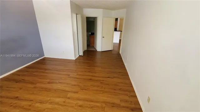 a kitchen with granite countertop a sink a stove and cabinets