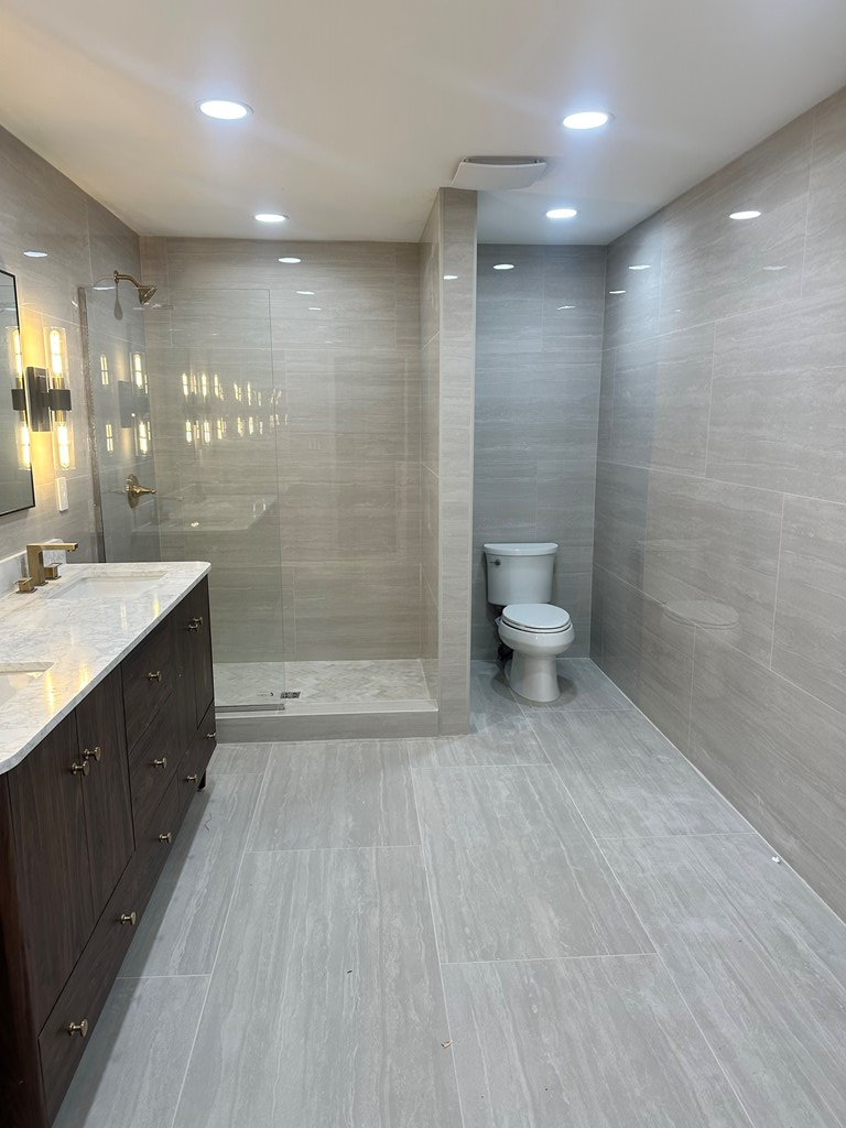 1432 22nd Street Columbus, GA 31901 - Photo 16 of 18 a bathroom with a double vanity sink toilet and shower