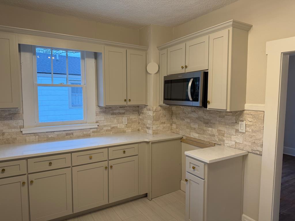 1432 22nd Street Columbus, GA 31901 - Photo 6 of 18 a kitchen with granite countertop white cabinets stainless steel appliances and sink