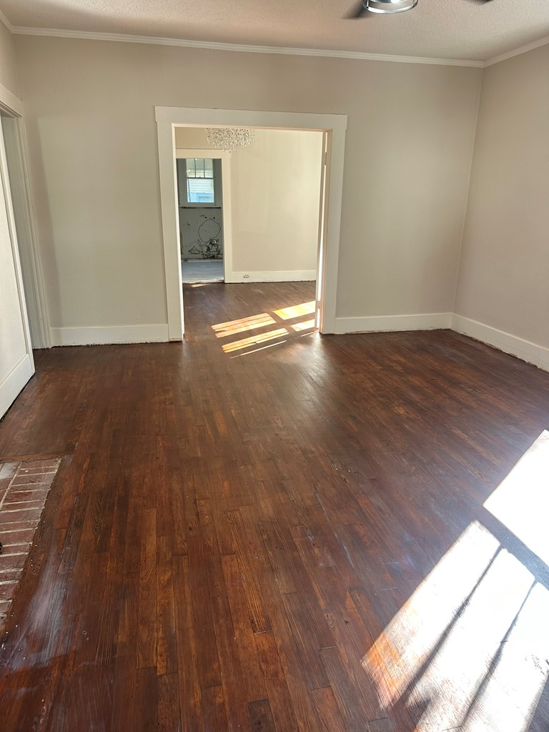 1432 22nd Street Columbus, GA 31901 - Photo 10 of 18 a view of an empty room with wooden floor and a window