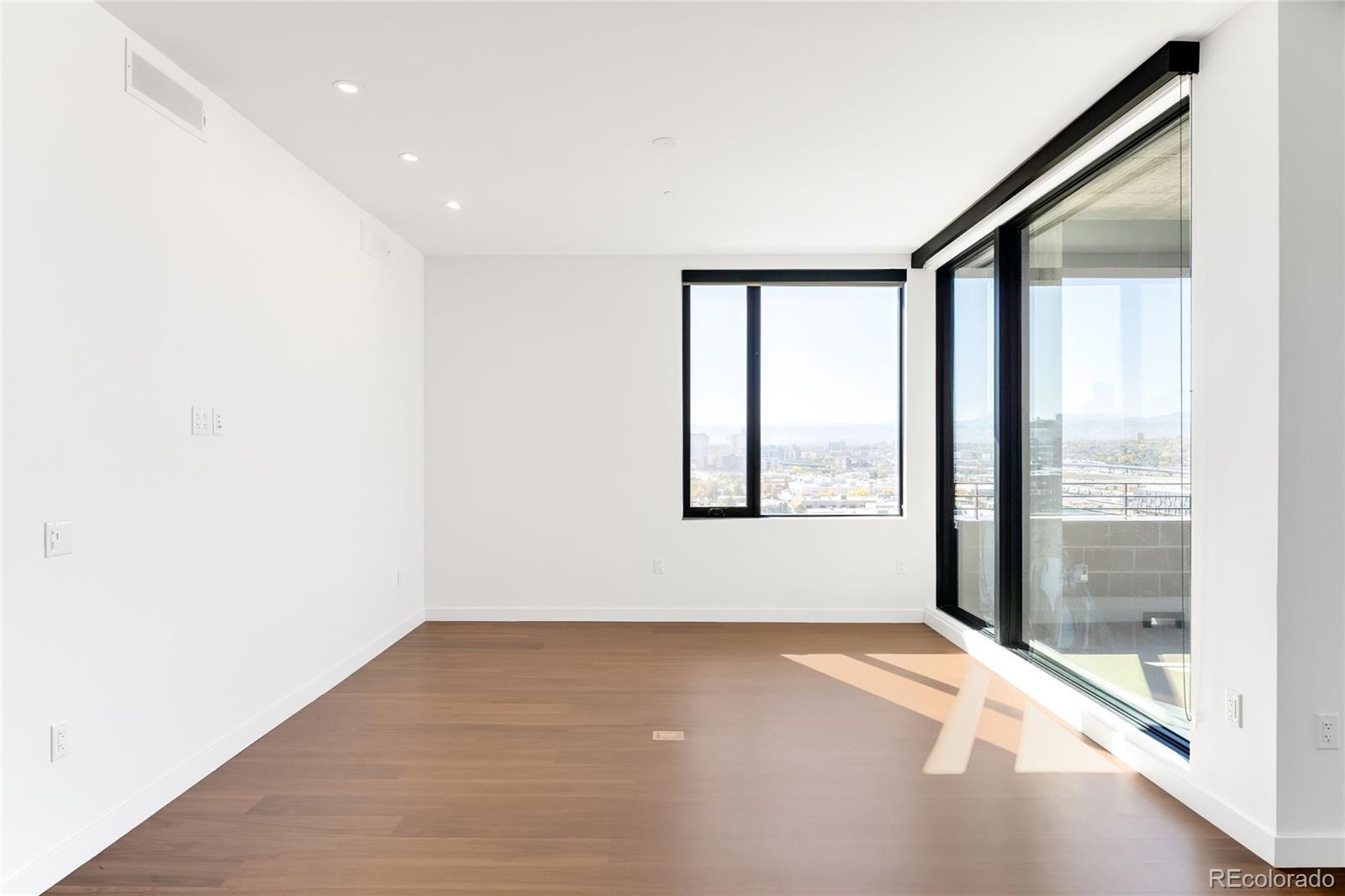 3520 Chestnut Place, Unit 1101 Denver, CO 80216 - Photo 11 of 44 a view of an empty room with a window