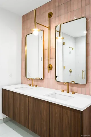 a bathroom with a double vanity sink and a mirror