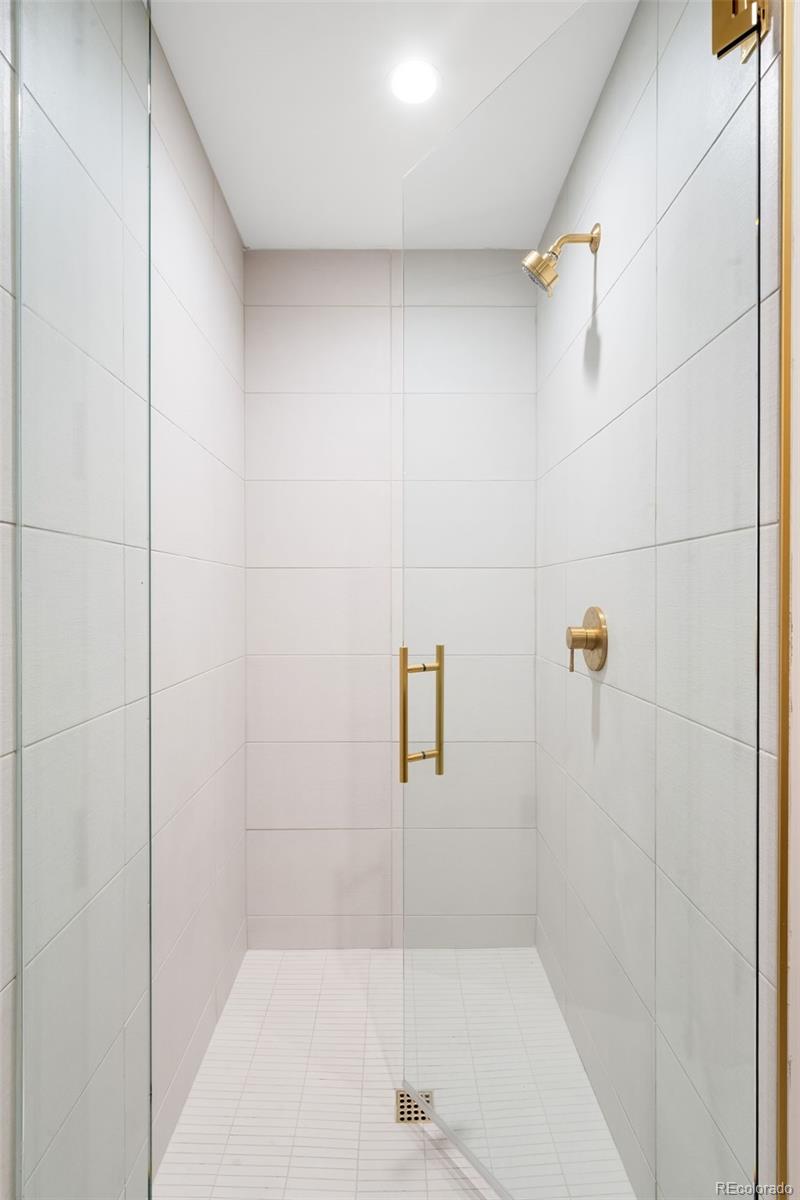 3520 Chestnut Place, Unit 1101 Denver, CO 80216 - Photo 28 of 44 a bathroom with a shower