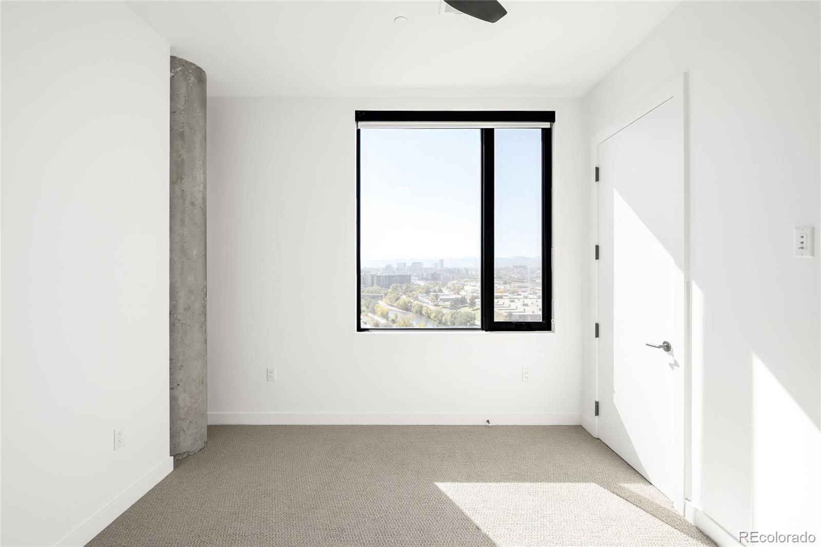 3520 Chestnut Place, Unit 1101 Denver, CO 80216 - Photo 29 of 44 a view of an empty room with a window