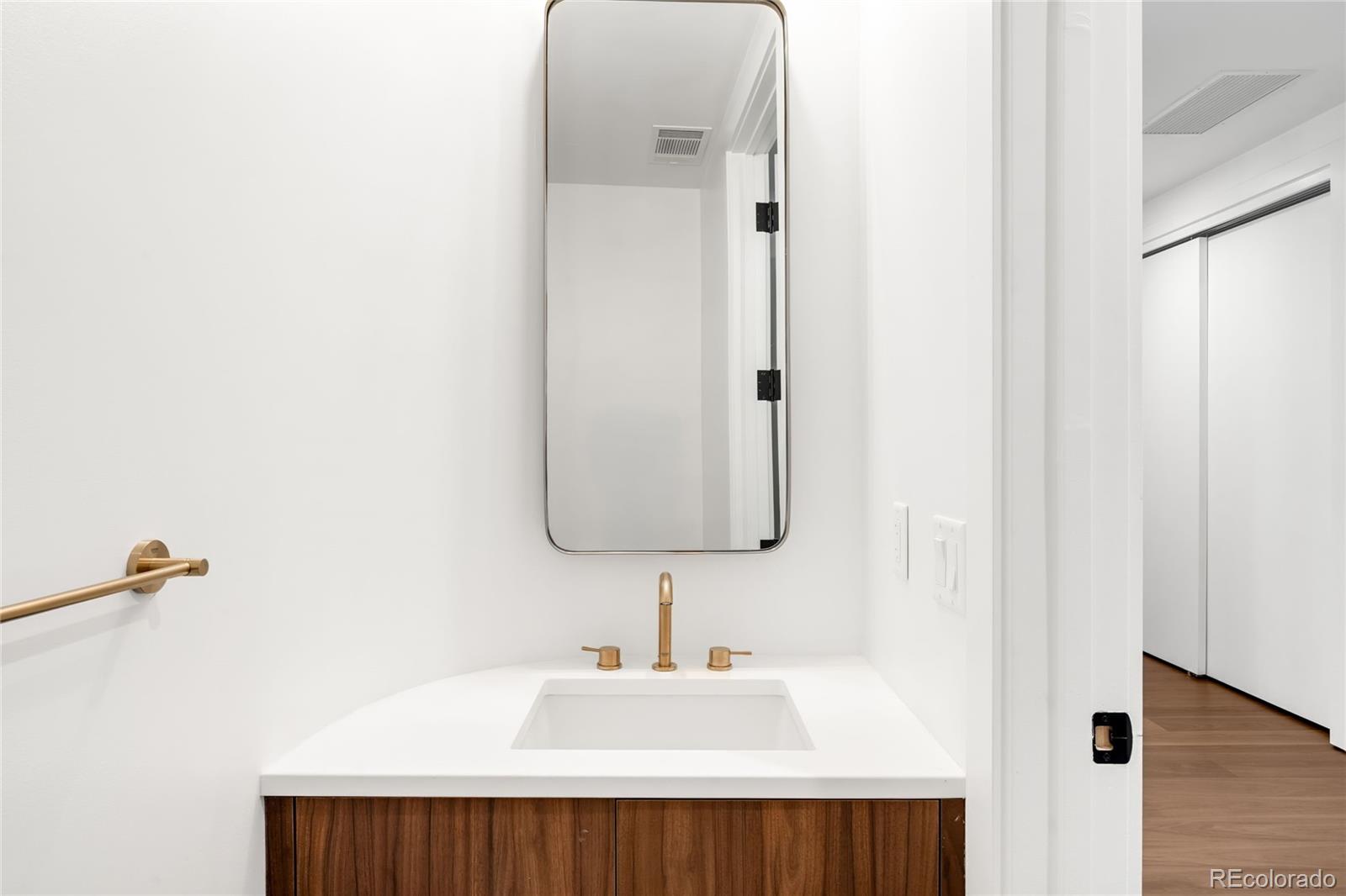 3520 Chestnut Place, Unit 1101 Denver, CO 80216 - Photo 34 of 44 a bathroom with a sink and a mirror