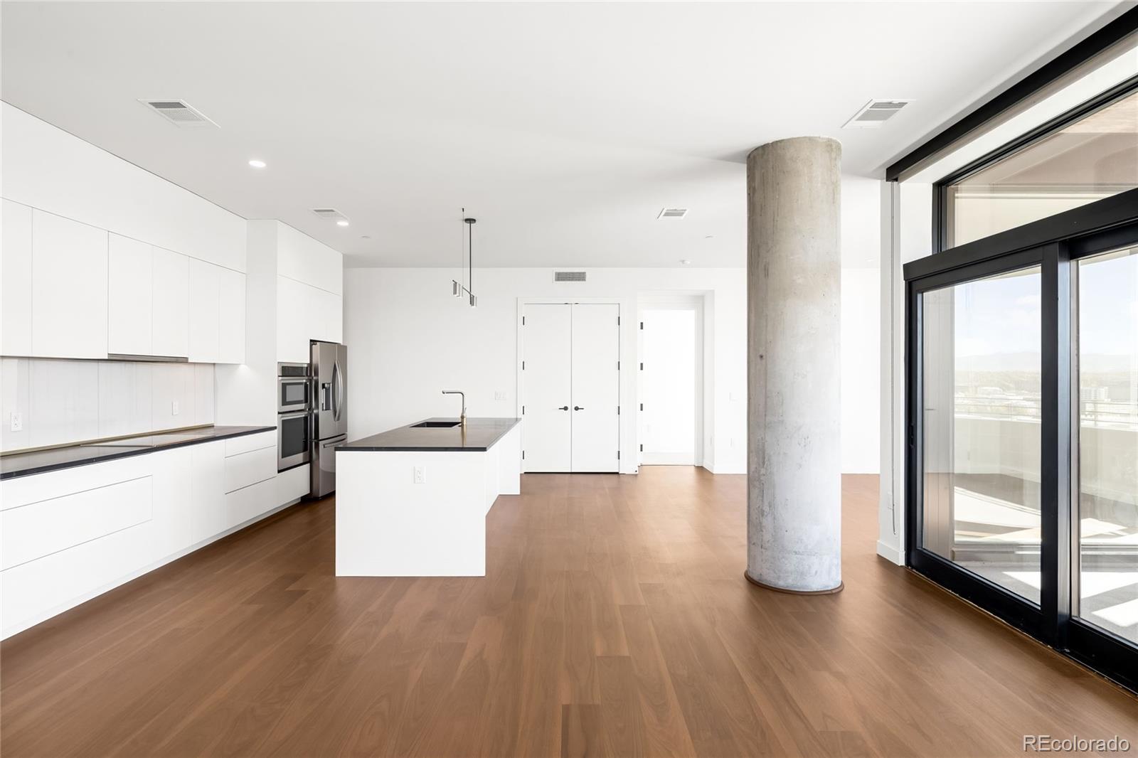 3520 Chestnut Place, Unit 1101 Denver, CO 80216 - Photo 10 of 44 a view of a kitchen with wooden floor