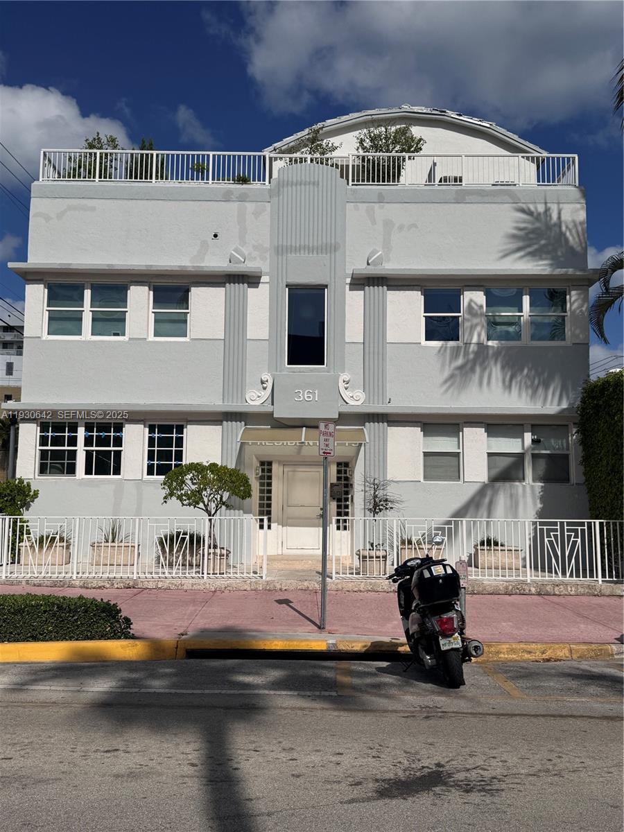 a view of building with glass windows and a table