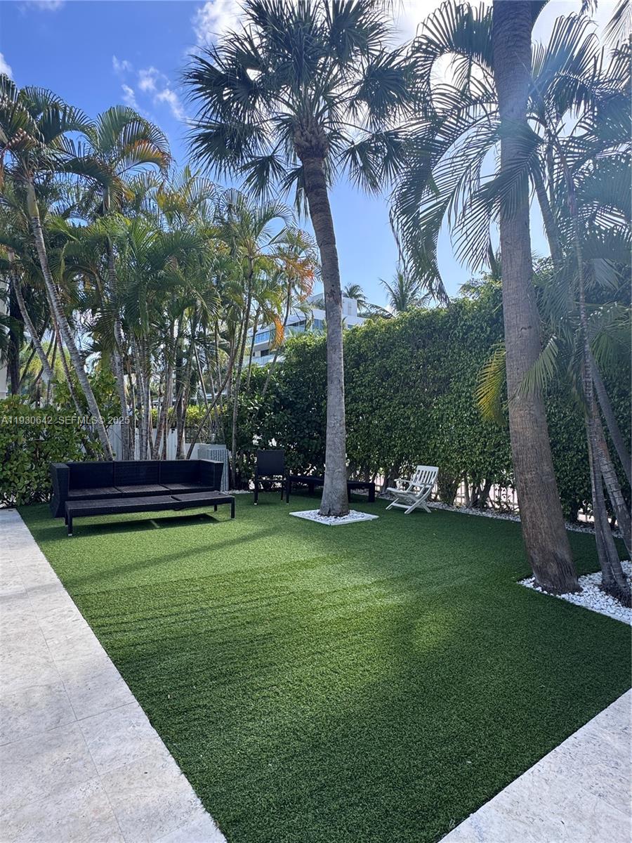 361 Collins Avenue, Unit A2 Miami Beach, FL 33139 - Photo 2 of 25 a view of a park with large trees