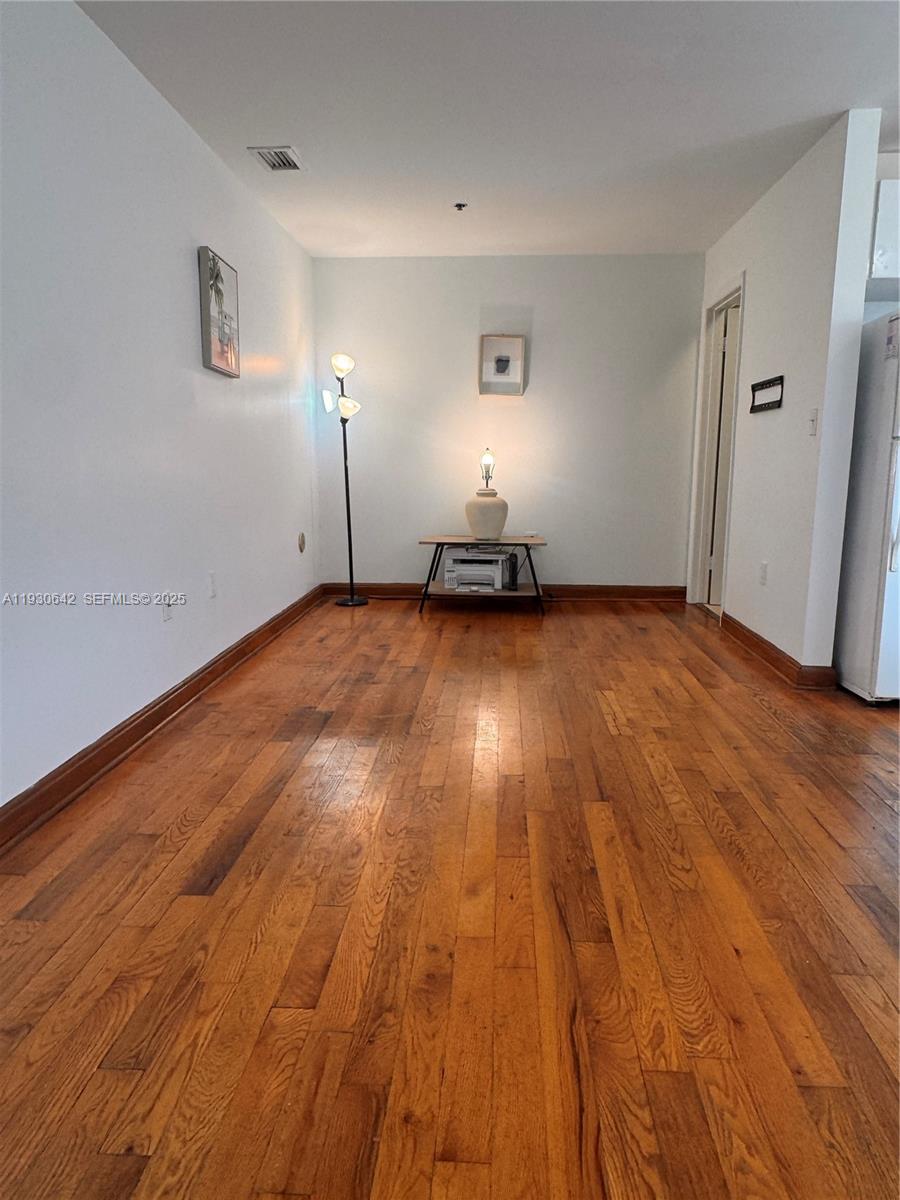 361 Collins Avenue, Unit A2 Miami Beach, FL 33139 - Photo 21 of 25 a view of a room with wooden floor