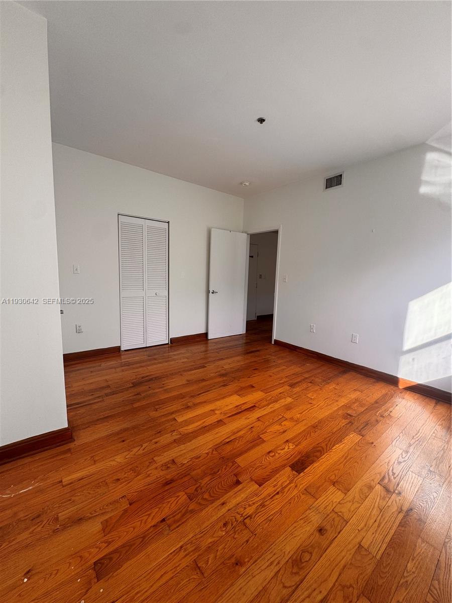 361 Collins Avenue, Unit A2 Miami Beach, FL 33139 - Photo 25 of 25 a view of empty room with wooden floor