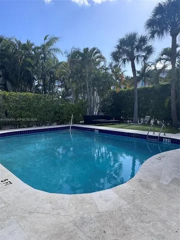 a view of a swimming pool with a yard
