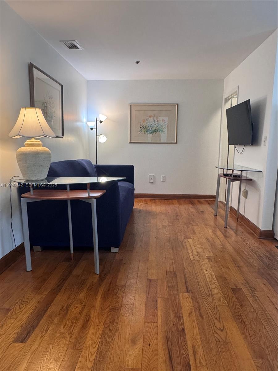 361 Collins Avenue, Unit A2 Miami Beach, FL 33139 - Photo 5 of 25 a view of a livingroom with furniture wooden floor and window